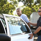 A documented gang member is put into a patrol car by a police officer in one of the worst neighborhoods of Santa Ana, Calif. (Credit: Los Angeles Times)